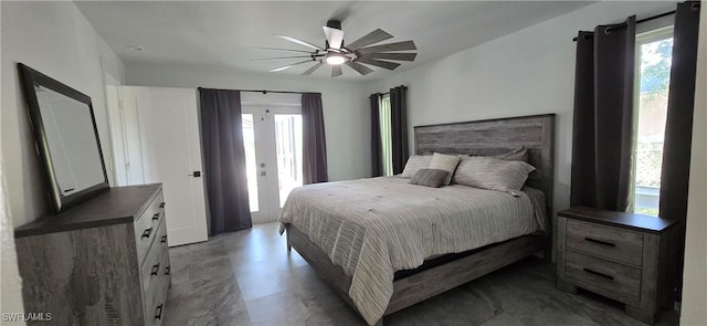 bedroom featuring concrete floors, access to exterior, and ceiling fan