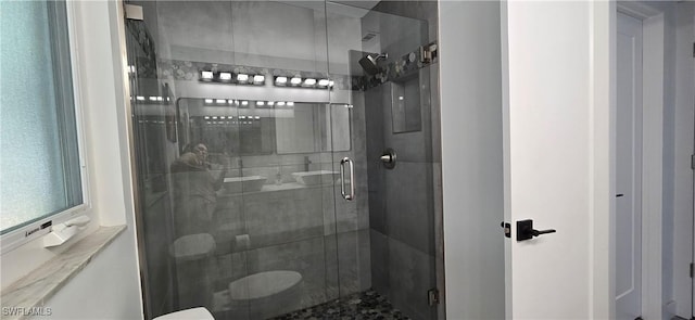 bathroom featuring a shower stall and toilet