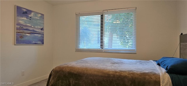 bedroom with multiple windows and baseboards