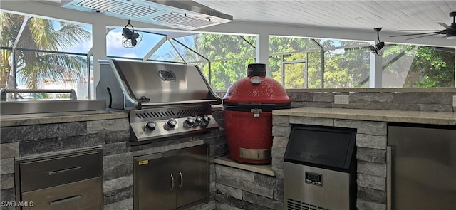 view of patio with exterior kitchen, grilling area, glass enclosure, and ceiling fan