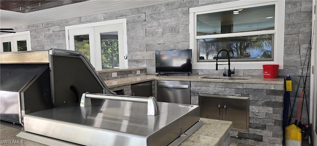 bar area featuring a sink and dishwasher
