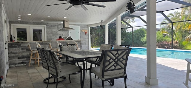 view of patio / terrace featuring a ceiling fan, an outdoor pool, french doors, and a lanai