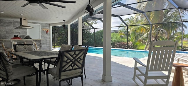 swimming pool with ceiling fan, a patio, outdoor dining space, area for grilling, and a lanai