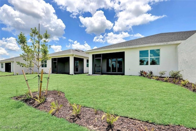 44311 Panther Dr, Punta Gorda, FL 33982 - back of house featuring a sunroom, a lawn, and stucco siding