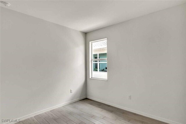 44311 Panther Dr, Punta Gorda, FL 33982 - spare room with light wood-type flooring, baseboards, and a smoke detector