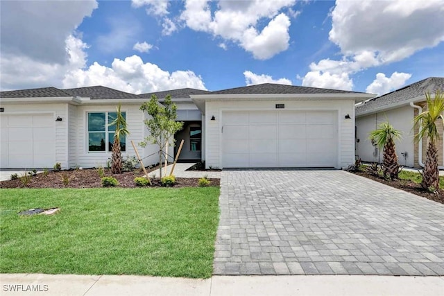44311 Panther Dr, Punta Gorda, FL 33982 - view of front of home featuring an attached garage, decorative driveway, and a front lawn