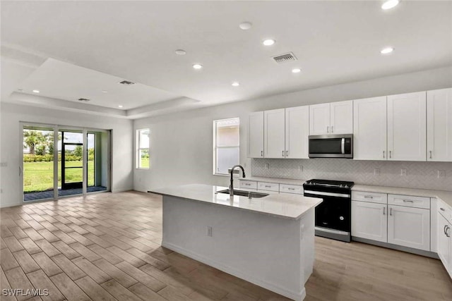 44311 Panther Dr, Punta Gorda, FL 33982 - kitchen featuring electric stove, stainless steel microwave, a sink, light wood-type flooring, and recessed lighting