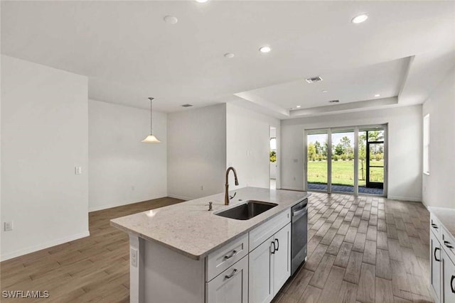 44311 Panther Dr, Punta Gorda, FL 33982 - kitchen with a sink, open floor plan, a raised ceiling, wood finished floors, and recessed lighting