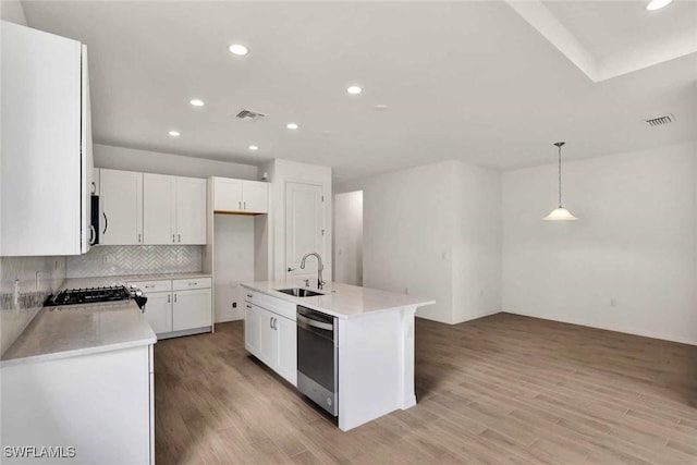 44311 Panther Dr, Punta Gorda, FL 33982 - kitchen with stainless steel dishwasher, a sink, recessed lighting, light countertops, and light wood-type flooring