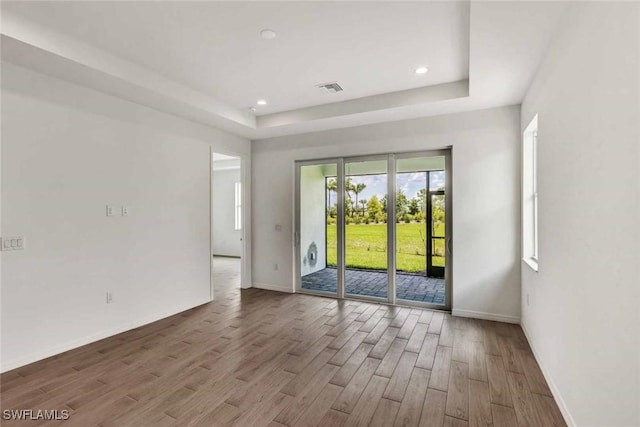 44311 Panther Dr, Punta Gorda, FL 33982 - spare room featuring wood finished floors, baseboards, a raised ceiling, and recessed lighting