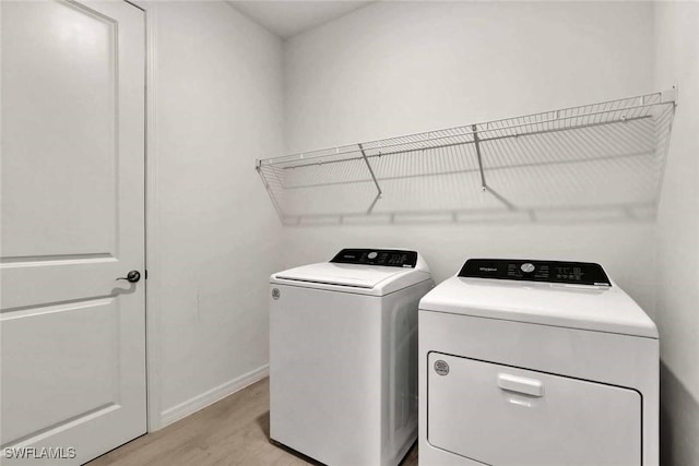 44311 Panther Dr, Punta Gorda, FL 33982 - laundry room featuring independent washer and dryer, light wood-style floors, and baseboards