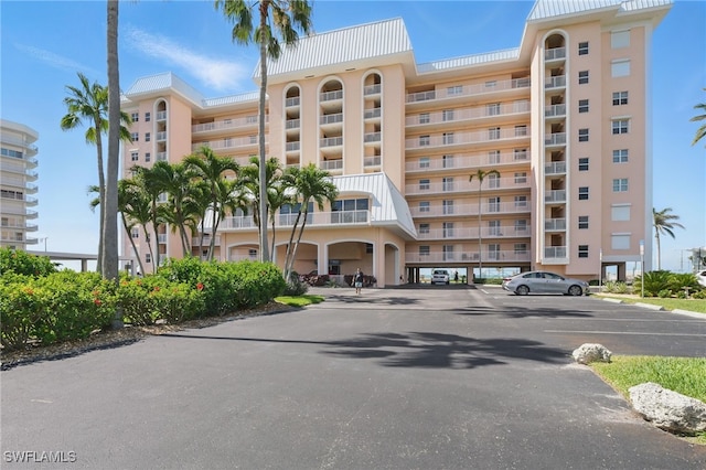 1020 S Collier Blvd Unit 402, Marco Island, FL 34145 - view of apartment building / complex featuring uncovered parking