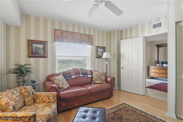 1020 S Collier Blvd Unit 402, Marco Island, FL 34145 - living room featuring wallpapered walls, light wood-style flooring, and a ceiling fan