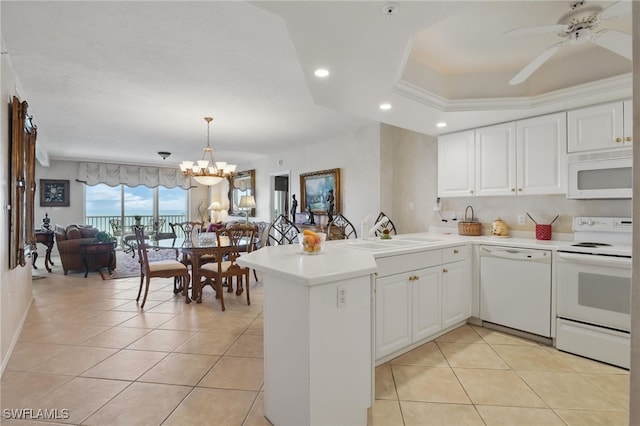 1020 S Collier Blvd Unit 402, Marco Island, FL 34145 - kitchen with white appliances, a sink, a peninsula, light tile patterned flooring, and recessed lighting