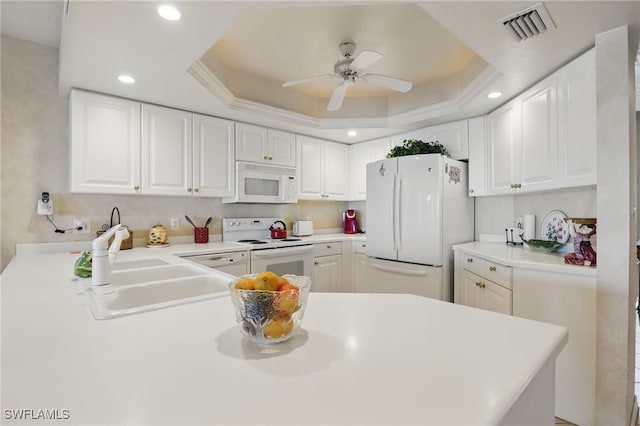 1020 S Collier Blvd Unit 402, Marco Island, FL 34145 - kitchen with white appliances, a sink, a raised ceiling, ceiling fan, and white cabinetry