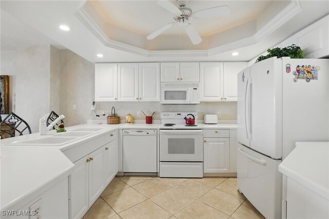 1020 S Collier Blvd Unit 402, Marco Island, FL 34145 - kitchen featuring white appliances, white cabinetry, a tray ceiling, light countertops, and light tile patterned floors