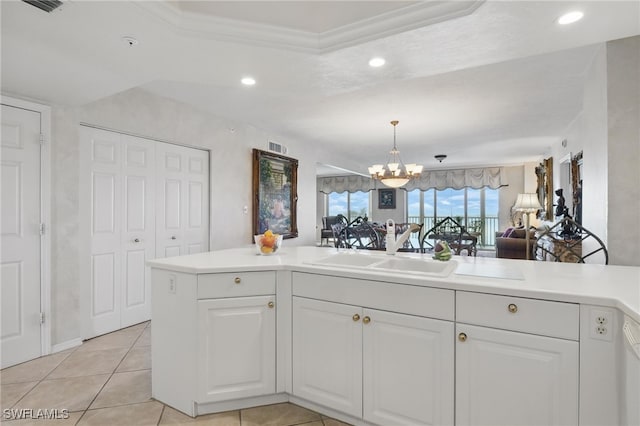 1020 S Collier Blvd Unit 402, Marco Island, FL 34145 - kitchen with a chandelier, a sink, recessed lighting, light countertops, and white cabinets