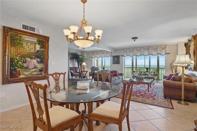 1020 S Collier Blvd Unit 402, Marco Island, FL 34145 - dining space featuring light tile patterned floors, a chandelier, and baseboards