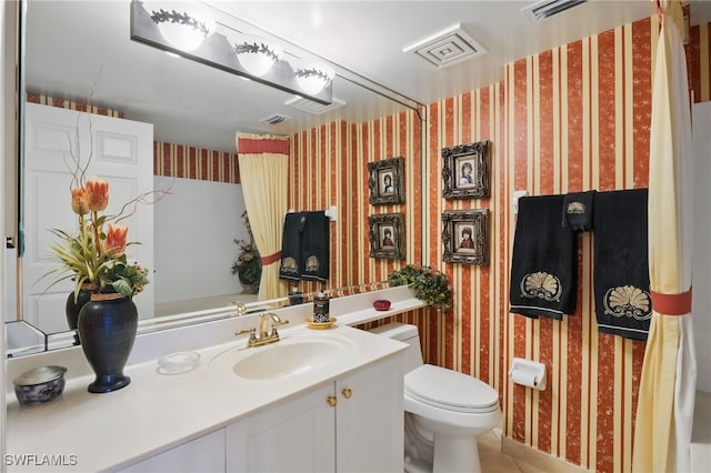 1020 S Collier Blvd Unit 402, Marco Island, FL 34145 - bathroom with wallpapered walls, toilet, vanity, and tile patterned flooring