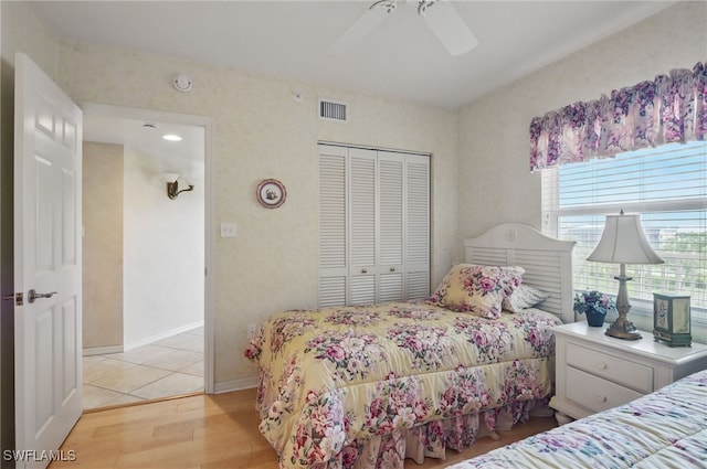 1020 S Collier Blvd Unit 402, Marco Island, FL 34145 - bedroom featuring a closet, light wood-style flooring, and a ceiling fan