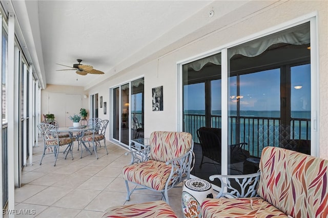1020 S Collier Blvd Unit 402, Marco Island, FL 34145 - sunroom with ceiling fan, tile patterned flooring, a water view, and outdoor dining space