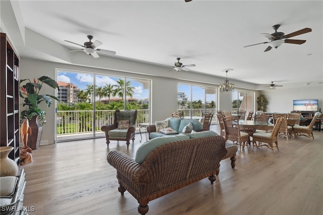1020 S Collier Blvd Unit 402, Marco Island, FL 34145 - living area featuring wood finished floors, a ceiling fan, and a chandelier