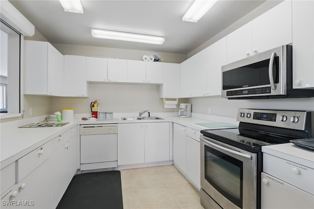 1020 S Collier Blvd Unit 402, Marco Island, FL 34145 - kitchen with stainless steel appliances, a sink, light countertops, white cabinetry, and light tile patterned floors