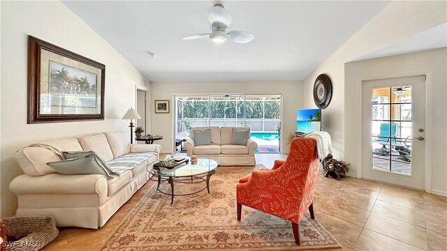 living area with ceiling fan and light tile patterned floors