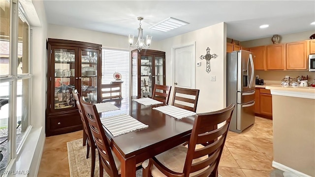 dining area with a chandelier, light tile patterned floors, and recessed lighting
