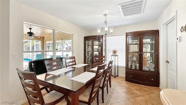 dining room featuring a chandelier, a ceiling fan, light tile patterned flooring, and baseboards