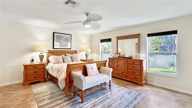 bedroom with light tile patterned floors, baseboards, and ceiling fan