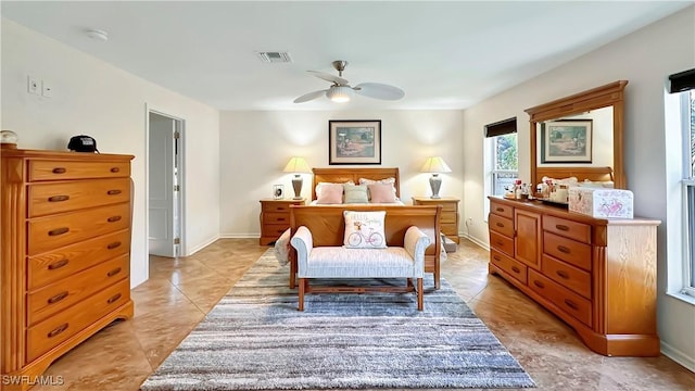bedroom with ceiling fan, light tile patterned flooring, and baseboards