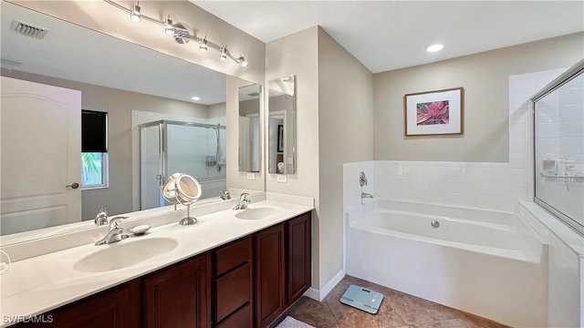 full bathroom featuring a garden tub, a stall shower, tile patterned floors, double vanity, and baseboards