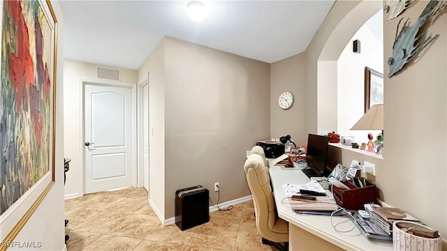 home office with light tile patterned floors and baseboards