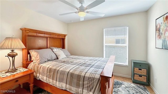 bedroom featuring ceiling fan, light colored carpet, and baseboards