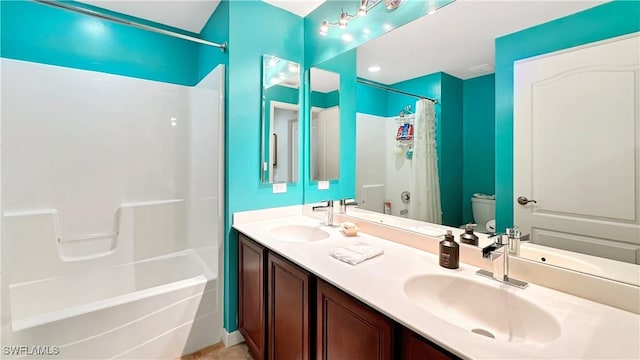 bathroom featuring toilet, shower / bath combo with shower curtain, and double vanity