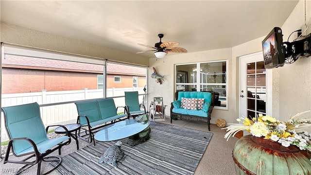 sunroom / solarium with a ceiling fan and outdoor lounge area