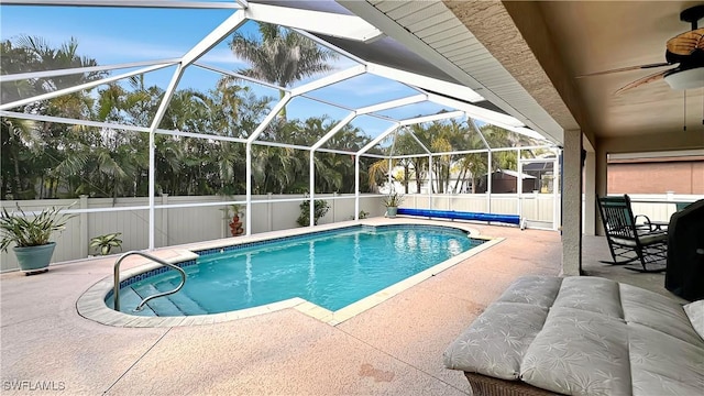 view of swimming pool featuring a ceiling fan, a patio, a fenced backyard, and a lanai
