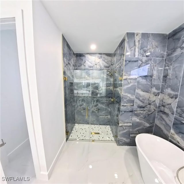 bathroom with a marble finish shower and a soaking tub