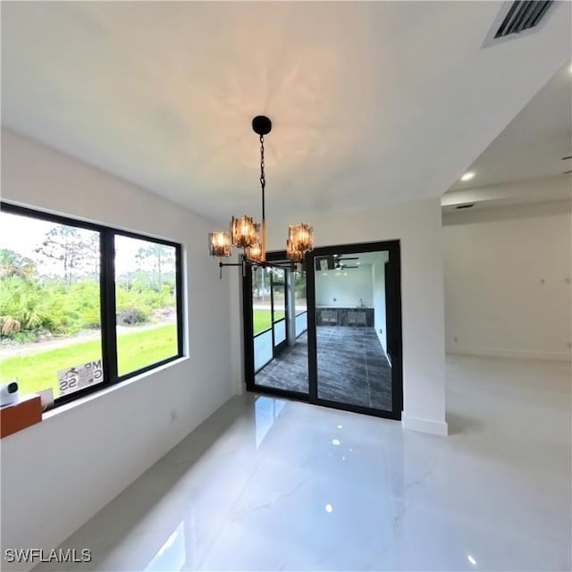 unfurnished dining area with a chandelier