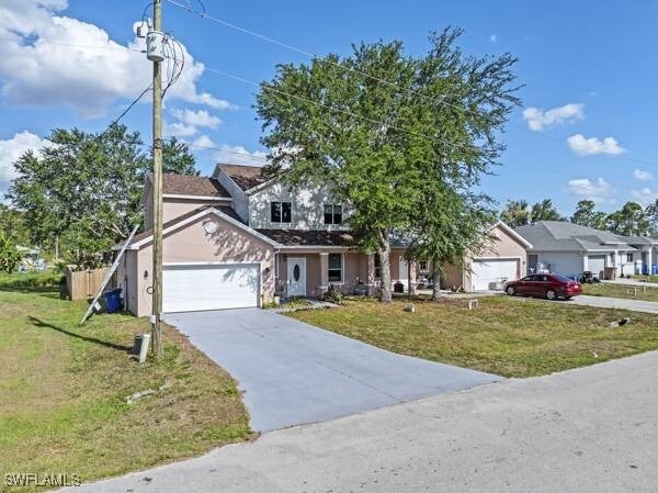 857 Bedford Dr, Lehigh Acres, FL 33974 - view of front of property with an attached garage, a front lawn, stucco siding, and driveway