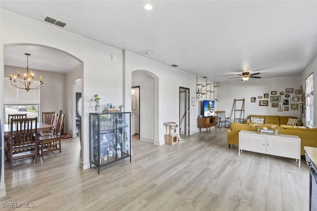 857 Bedford Dr, Lehigh Acres, FL 33974 - living room featuring arched walkways, a ceiling fan, and light wood-style floors