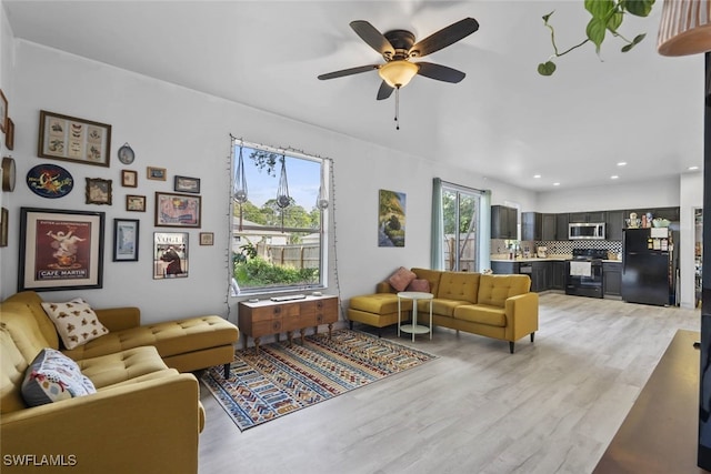 857 Bedford Dr, Lehigh Acres, FL 33974 - living area with light wood-style flooring, ceiling fan, and recessed lighting