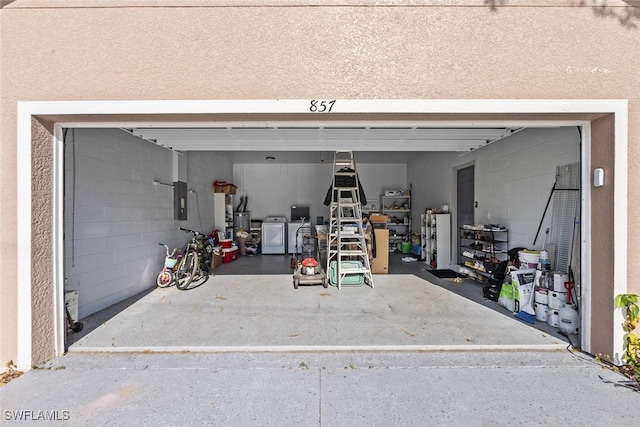 857 Bedford Dr, Lehigh Acres, FL 33974 - garage featuring washing machine and clothes dryer and electric panel