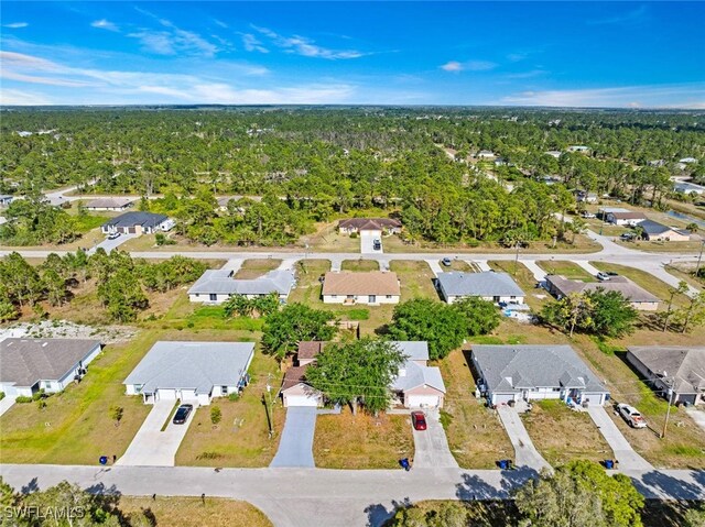 857 Bedford Dr, Lehigh Acres, FL 33974 - aerial overview of property's location featuring nearby suburban area and a heavily wooded area