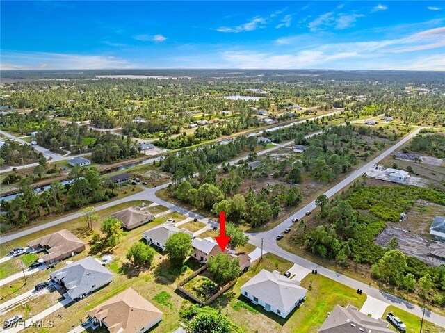 857 Bedford Dr, Lehigh Acres, FL 33974 - aerial view of property and surrounding area with nearby suburban area