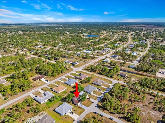 857 Bedford Dr, Lehigh Acres, FL 33974 - aerial view of property and surrounding area with nearby suburban area and a nearby body of water
