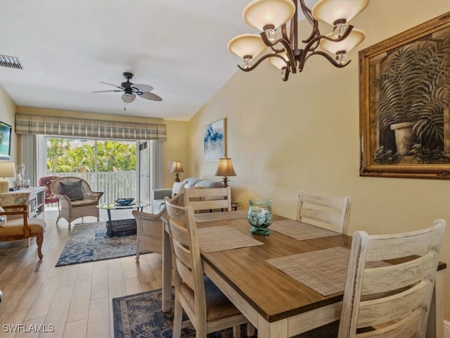 850 Elkhorn Ct Unit 222, Marco Island, FL 34145 - dining space featuring ceiling fan, lofted ceiling, wood finished floors, and a chandelier