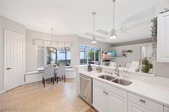 kitchen featuring a sink, dishwasher, white cabinetry, and light countertops