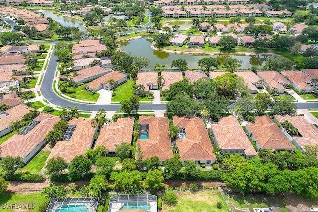 aerial view of property and surrounding area with nearby suburban area and a nearby body of water